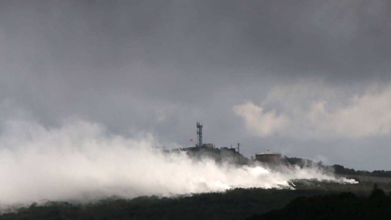 A picture taken on October 15, 2023, shows smoke billowing near an Israeli military site close to the southern Lebanese border village of Aita al-Shaab, following shelling by Hezbollah. Lebanon's Hezbollah and Israel exchanged deadly border fire Sunday, with the Iran-backed group claiming responsibility for strikes that Israel said killed a civilian, further raising cross-border tensions during Israel's war with Gaza-based militants. (Photo by AFP)