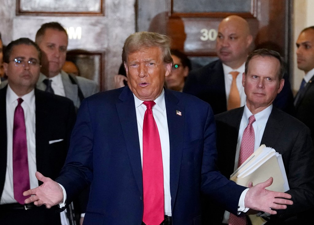 Former President Donald Trump speaks to the press during a break from court in his $250 million civil fraud trial against him and his company October 17, 2023. Trump attends the trial a day after a federal judge, in a separate criminal case, imposed a partial gag order on Trump, on October 16. (Photo by TIMOTHY A. CLARY / AFP)