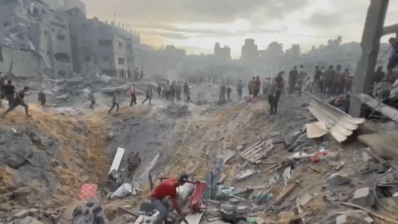 This image grab taken from AFPTV video footage shows Palestinians looking for survivors in a crater following a stike on a refugee camp in Jabalia on the northern Gaza Strip, on October 31, 2023, amid relentless Israeli bombardment of the Palestinian territory. The health ministry in the Hamas-run Gaza Strip said at least 50 people were killed on October 31 in Israeli bombardment of the refugee camp in the Palestinian territory.