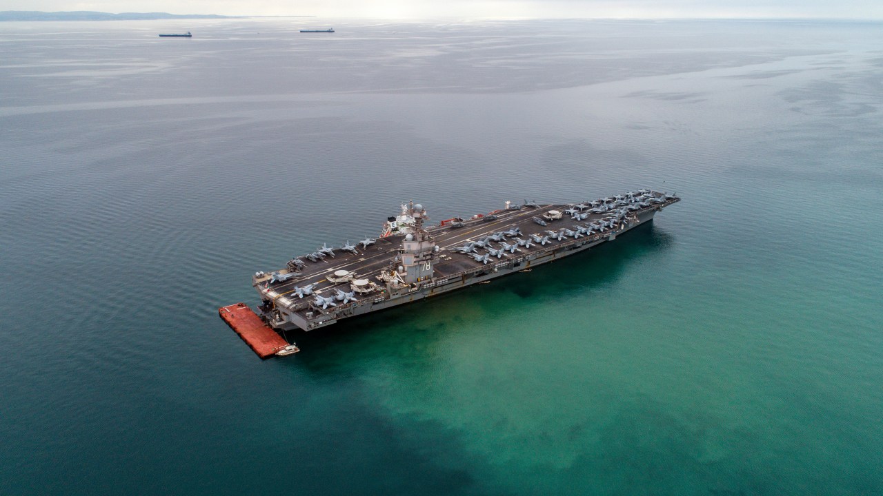 TRIESTE, ITALY - 2023/09/18: EDITOR'S NOTE: (Image taken with a drone)American aircraft carrier USS Gerald R. Ford is seen from the air anchored in Italy in the Gulf of Trieste. The USS Gerald R. Ford is the largest warship in the world. (Photo by Andrej Tarfila/SOPA Images/LightRocket via Getty Images)
