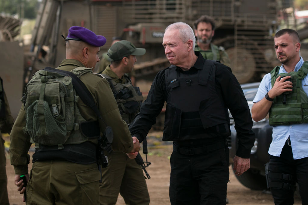 SDEROT, ISRAEL - OCTOBER 19: Israeli Minister of Defence Yoav Gallant meets soldiers on the Israeli border with the Gaza Strip on October 19, 2023 in Sderot, Israel. As Israel prepares to invade the Gaza Strip in its campaign to vanquish Hamas, the Palestinian militant group that launched a deadly attack in southern Israel on October 7th, worries are growing of a wider war with multiple fronts, including at the country's northern border with Lebanon. Countries have scrambled to evacuate their citizens from Israel, and Israel has begun relocating residents some communities on its northern border. Meanwhile, hundreds of thousands of residents of northern Gaza have fled to the southern part of the territory, following Israel's vow to launch a ground invasion. (Photo by Amir Levy/Getty Images)