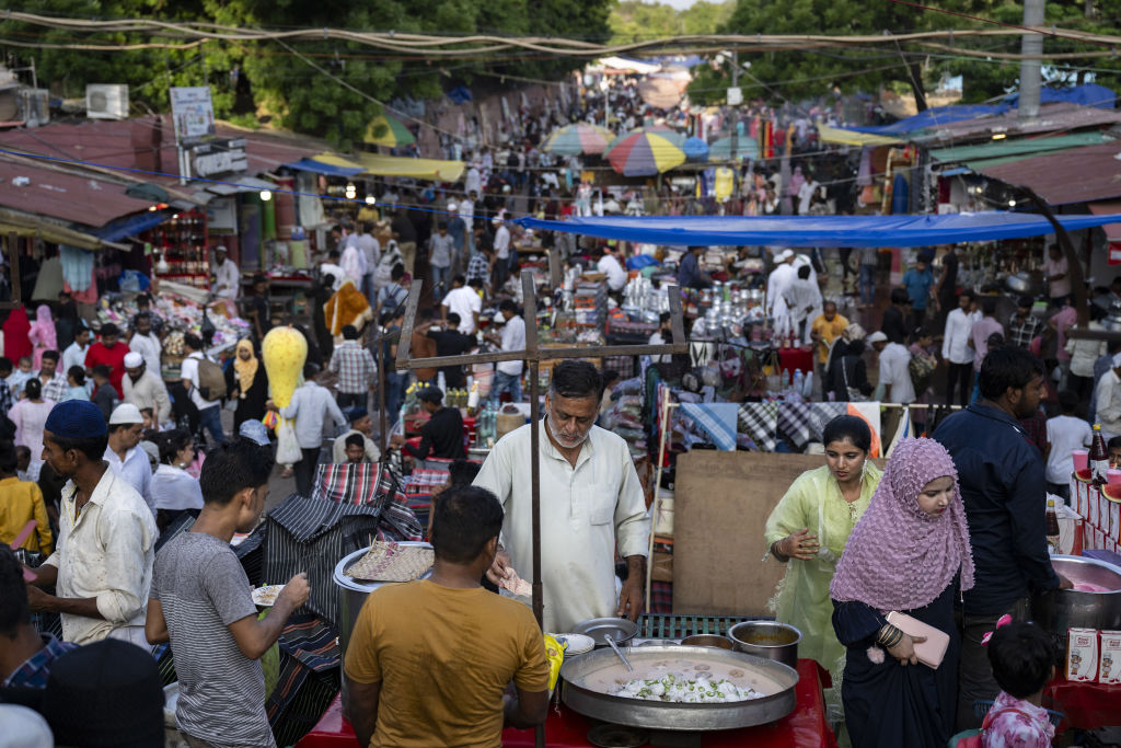 NEW DELHI, INDIA - SEPTEMBER 24: Street vendors from different cultures prepare and sell food on a crowded street as India, the world's most populous country with a population of approximately 1.5 billion according to United Nations estimates, contains different cultures for years in New Delhi, India on September 24, 2023. India's historical buildings, geography, cinema, music, dance, fashion, cuisine and rituals, has been preserved with its unique diversity for thousands of years. Surrounded by the sea on three sides, India is the 7th country in the world with the size of its geographical area. (Photo by Arif Hudaverdi Yaman/Anadolu Agency via Getty Images)