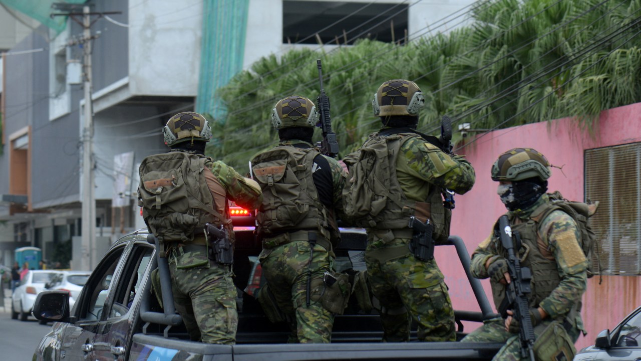 Ecuadorean security forces enter the premises of Ecuador's TC television channel after unidentified gunmen burst into the state-owned television studio live on air on January 9, 2024, in Guayaquil, Ecuador, a day after Ecuadorean President Daniel Noboa declared a state of emergency following the escape from prison of a dangerous narco boss. Gunshots rang out on live TV in violence-torn Ecuador as armed men carrying rifles and grenades stormed the studio shortly after gangsters vowed a "war" against the president's plans to reclaim control from "narcoterrorists". (Photo by STRINGER / AFP)