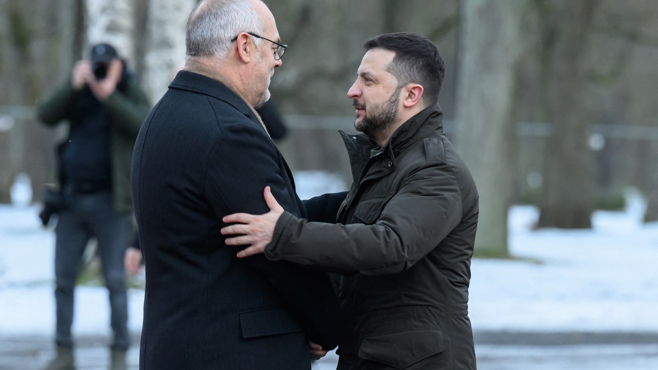 Ukraine's President Volodymyr Zelensky (R) is greeted by Estonia's President Alar Karis after his arrival in Tallinn, Estonia on January 11, 2024. Ukraine's President Volodymyr Zelensky was in Estonia on January 11, 2024 on the second leg of a Baltic tour aimed at boosting flagging support in his country's fight against Russia. (Photo by RAIGO PAJULA / AFP)