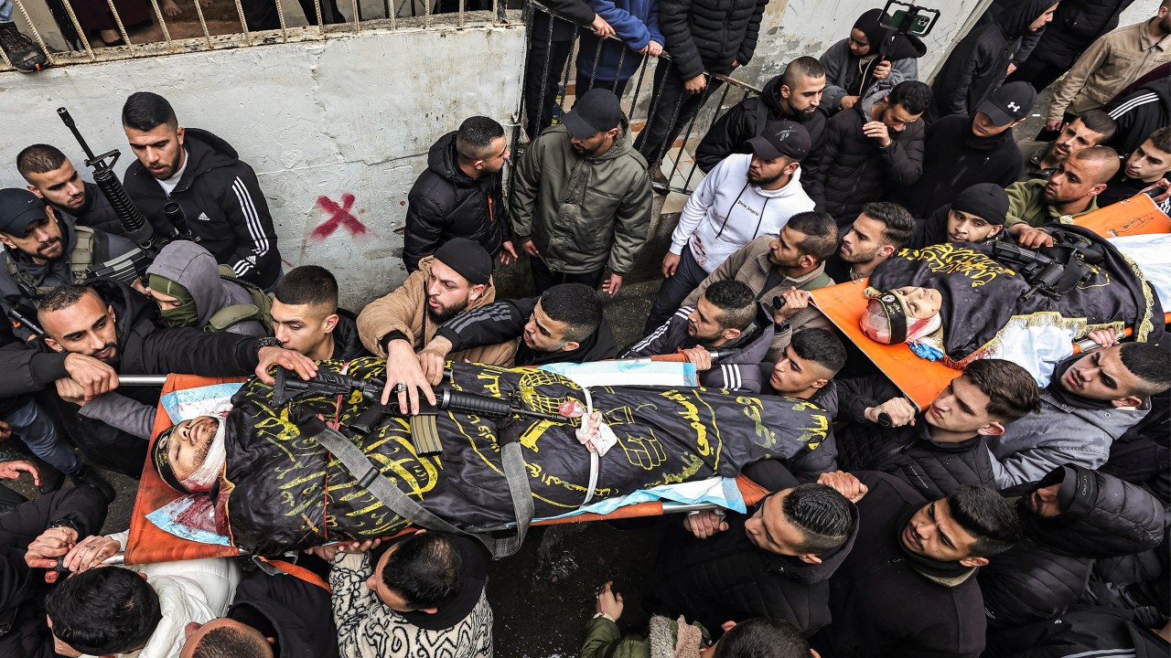 EDITORS NOTE: Graphic content / Mourners march carrying the bodies of the two Ghazawi brothers, who were among three Palestinian men killed when undercover Israeli agents raided the Ibn Sina hospital in the city of Jenin, during the funeral in the occupied West Bank city on January 30, 2024. Israeli forces shot dead three Palestinians at the hospital early on January 30, the Palestinian health ministry said, while the army said the three belonged to a Hamas "terrorist cell". The operation is the first such deadly incursion in years. (Photo by Zain JAAFAR / AFP)