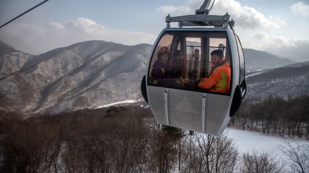 WONSAN, NORTH KOREA - FEBRUARY 05: North Korean skiers ride in a cable car to the summit of the 1,360-metre Taehwa Peak at Masikryong Ski Resort on February 05, 2019 near Wonsan, North Korea. U.S President Donald Trump and North Korean Supreme Leader Kim Jong Un will hold a second summit in the Vietnamese capital of Hanoi later this month following a historic summit in Singapore last June. Although the two countries remain technically at war and with negotiations surrounding the details of North Korea's nuclear disarmament continuing, President Trump has hailed Kim Jong Un and North Korea with a tweet in which he predicted that the country would become "a great economic powerhouse" thanks to Mr Kim's leadership. (Photo by Carl Court/Getty Images)