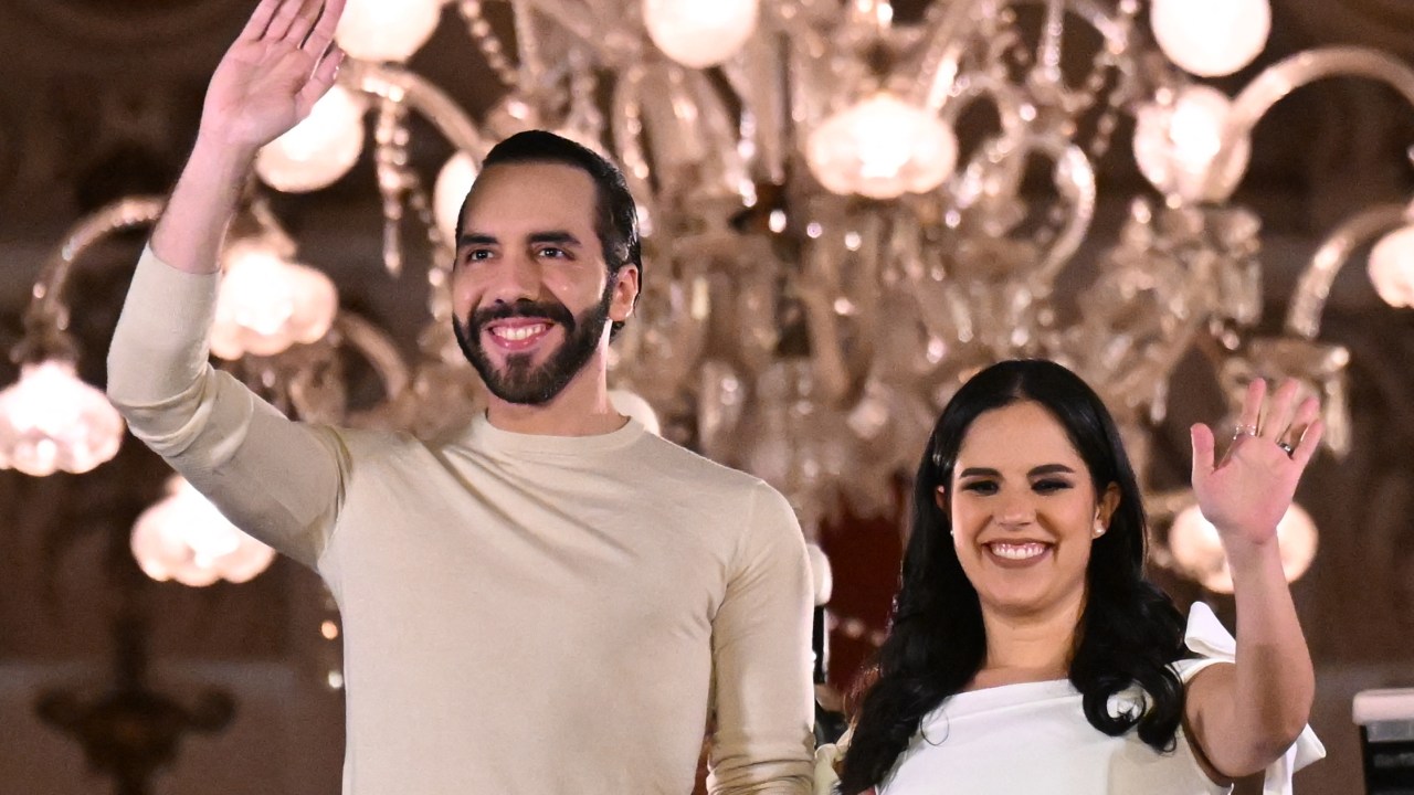 Salvadoran President Nayib Bukele greets supporters next to his wife Gabriela Rodriguez after the presidential and legislative elections in San Salvador on February 4, 2024. Fireworks erupted in El Salvador's capital as gang-busting President Nayib Bukele claimed to have won reelection with more than 85 percent of votes cast: "a record in the entire democratic history of the world." (Photo by Marvin RECINOS / AFP)
