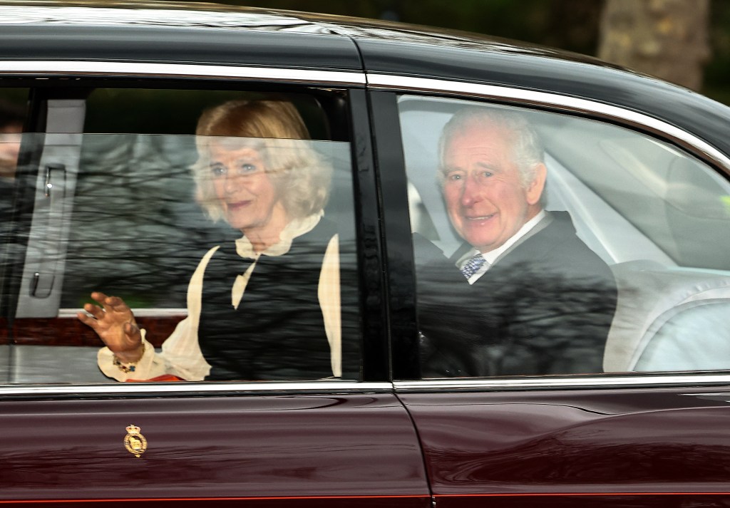 Britain's King Charles III and Britain's Queen Camilla wave as they leave by car from Clarence House in London on February 6, 2024. King Charles III's estranged son Prince Harry reportedly arrived in London on Tuesday after his father's diagnosis of cancer, which doctors "caught early". (Photo by HENRY NICHOLLS / AFP)