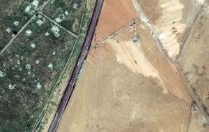 This handout satellite picture taken and released by Maxar Technologies on February 15, 2024 shows machinery building a wall along the Egypt-Gaza Strip border in Rafah, Egypt. Hundreds of thousands of displaced Palestinians have been driven into Gaza's southernmost city by Israel's relentless military campaign, seeking shelter in a sprawling makeshift encampment near the Egypt border. (Photo by Handout / Satellite image ©2024 Maxar Technologies / AFP) / RESTRICTED TO EDITORIAL USE - MANDATORY CREDIT "AFP PHOTO / Satellite image ©2024 Maxar Technologies " - NO MARKETING - NO ADVERTISING CAMPAIGNS - DISTRIBUTED AS A SERVICE TO CLIENTS - THE WATERMARK MAY NOT BE REMOVED/CROPPED
