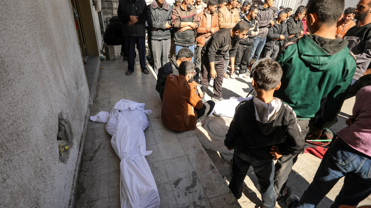 EDITORS NOTE: Graphic content / Palestinians mourn near bodies at Kamal Edwan Hospital in Beit Lahia, in the northern Gaza Strip, on February 29, 2024, after Israeli soldiers allegedly opened fire at Gaza residents who rushed towards trucks loaded with humanitarian aid amid ongoing battles between Israel and the militant Hamas group. A Gaza emergency doctor said on February 29 that Israeli forces shot dead at least 50 people who rushed towards trucks loaded with humanitarian aid for Gaza City residents. The Israeli army said it was "checking" the reports on the incident, while the United Nations' humanitarian office OCHA said it was "familiar with the reports". (Photo by AFP)