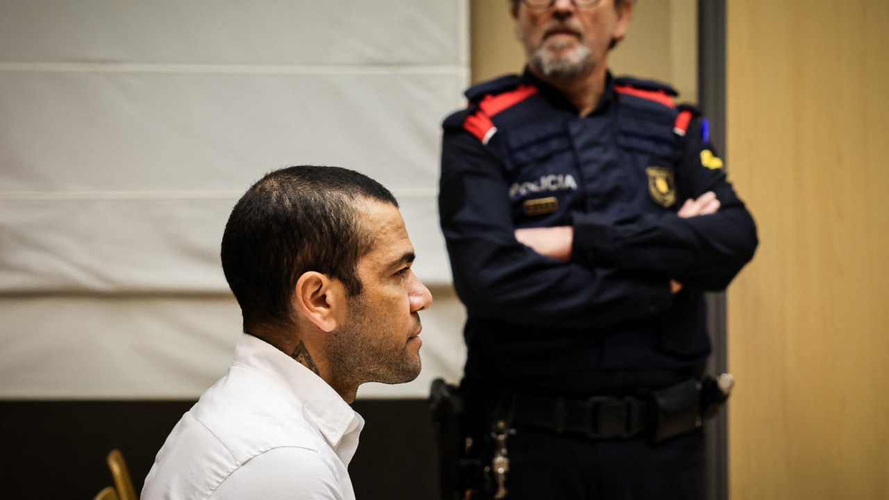 Brazilian footballer Dani Alves looks on at the start of his trial at the High Court of Justice of Catalonia in Barcelona, on February 5, 2024. Brazilian footballer Dani Alves, a former star at Barca and PSG, goes on trial in Barcelona accused of raping a woman in a local nightclub. Prosecutors are asking for a nine-year prison sentence, followed by 10 years of conditional liberty. They are also asking he pay 150,000 euros ($162,000) in compensation to the woman. (Photo by Jordi BORRAS / POOL / AFP)