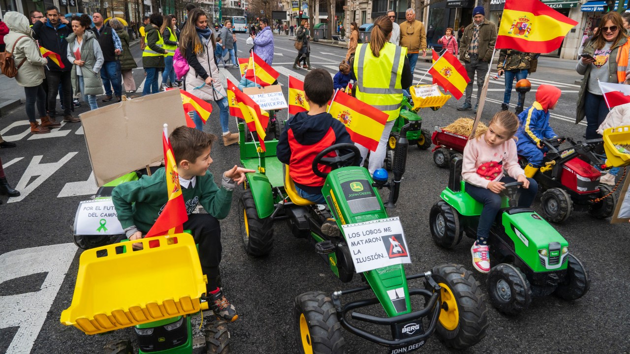 A group of children are accompanying and supporting their families with toy tractors during ''la Tractorada,'' a protest with tractors, in the streets of Santander, Spain, on February 16, 2024. Ranchers and farmers are protesting the delicate situation in the countryside, including wolf attacks on livestock, low prices of agricultural products, and bureaucratic obstacles. (Photo by Joaquin Gomez Sastre/NurPhoto via Getty Images)