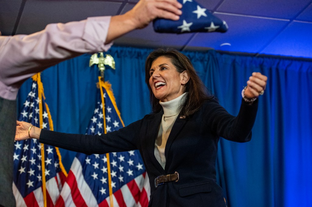 US Republican presidential hopeful and former UN Ambassador Nikki Haley reaches out to embraces Retired Brig. Gen. Donald Bolduc before speaking during a campaign rally in Portland, Maine, on March 3, 2024. (Photo by Joseph Prezioso / AFP)