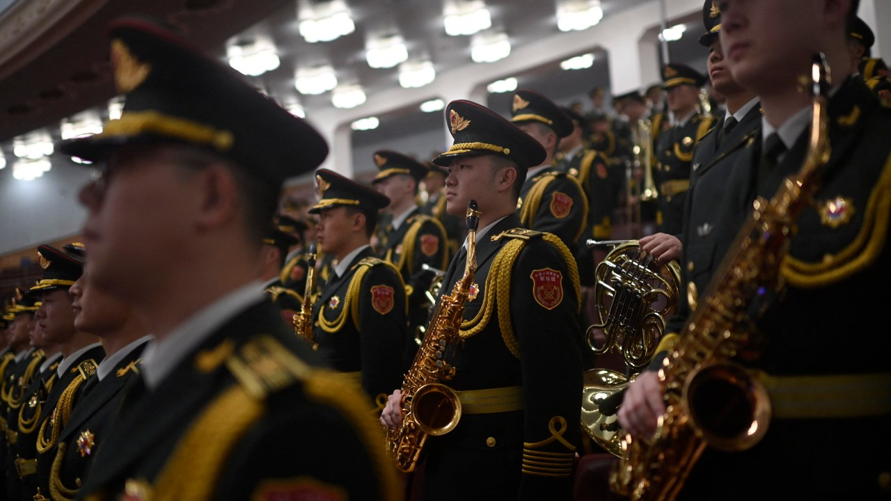 The People's Liberation Army (PLA) band stands before the opening session of the National People's Congress (NPC) at the Great Hall of the People in Beijing on March 5, 2024. (Photo by Pedro Pardo / AFP)