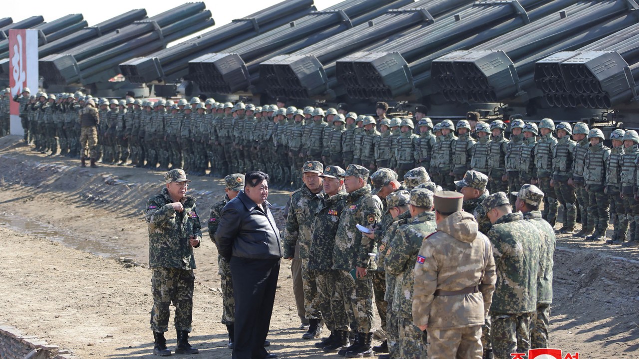 This picture taken on March 7, 2024 and released from North Korea's official Korean Central News Agency (KCNA) via KNS on March 8, 2024 shows North Korea's leader Kim Jong Un (2nd L) with members of the Korean People's Army (KPA) during a joint forces artillery training exercise at an undisclosed location in North Korea. (Photo by KCNA VIA KNS / AFP) / South Korea OUT / REPUBLIC OF KOREA OUT