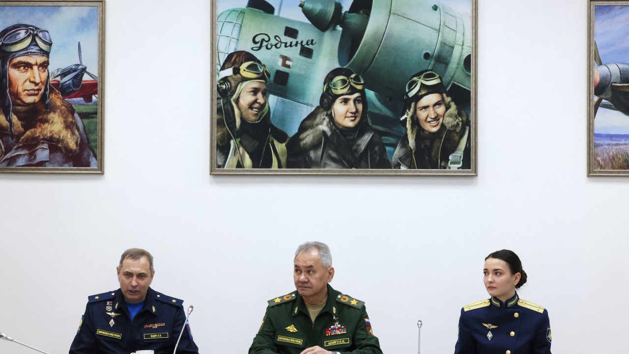 In this pool photograph distributed by Russian state owned agency Russia's Defence Minister Sergei Shoigu (C) and Deputy Commander-in-Chief of the Russian Aerospace Forces, Lieutenant General Andrei Yudin (L) attend a meeting with graduates of the Krasnodar Higher Military Aviation School of Pilots in Krasnodar on March 7, 2024. (Photo by Mikhail METZEL / SPUTNIK / AFP)