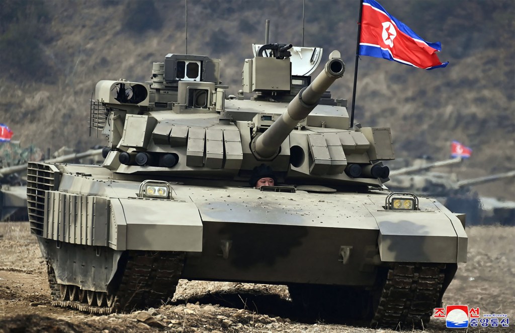 This picture taken on March 13, 2024 and released by North Korea's official Korean Central News Agency (KCNA) on March 14 shows North Korean leader Kim Jong Un (C) pictured in the driver's position of a new main battle tank after a training competition between the combined forces of the Korean People's Army tank crews at an undisclosed location in North Korea. (Photo by KCNA VIA KNS / AFP) / - South Korea OUT / ---EDITORS NOTE--- RESTRICTED TO EDITORIAL USE - MANDATORY CREDIT "AFP PHOTO/KCNA VIA KNS" - NO MARKETING NO ADVERTISING CAMPAIGNS - DISTRIBUTED AS A SERVICE TO CLIENTS THIS PICTURE WAS MADE AVAILABLE BY A THIRD PARTY. AFP CAN NOT INDEPENDENTLY VERIFY THE AUTHENTICITY, LOCATION, DATE AND CONTENT OF THIS IMAGE. /