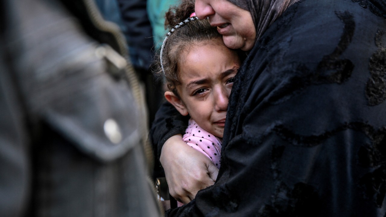 A Palestinian woman holds a child as they mourn their relatives killed in Israeli bombardment in front of the morgue of the Al-Shifa hospital in Gaza City on March 15, 2024, amid the ongoing conflict between Israel and the Palestinian Hamas movement. (Photo by AFP)
