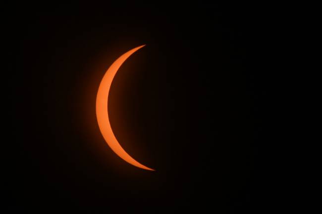 MEXICO-ASTRONOMY-ECLIPSE The moon begins to eclipse the sun during the total solar eclipse in Mazatlan, Sinaloa state, Mexico on April 8, 2024. This year's path of totality is 115 miles (185 kilometers) wide and home to nearly 32 million Americans, with an additional 150 million living less than 200 miles from the strip. The next total solar eclipse that can be seen from a large part of North America won't come around until 2044. (Photo by MARIO VAZQUEZ / AFP)