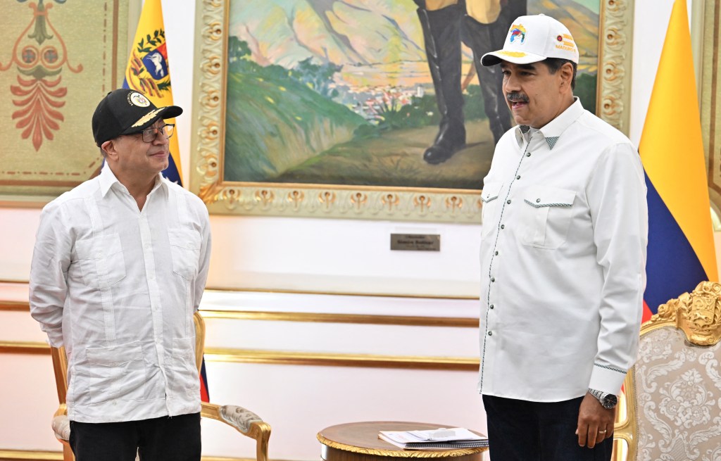 Colombian President Gustavo Petro (L) and his Venezuelan counterpart Nicolas Maduro chat during an official visit at Miraflores Palace in Caracas on April 9, 2024. (Photo by JUAN BARRETO / AFP)