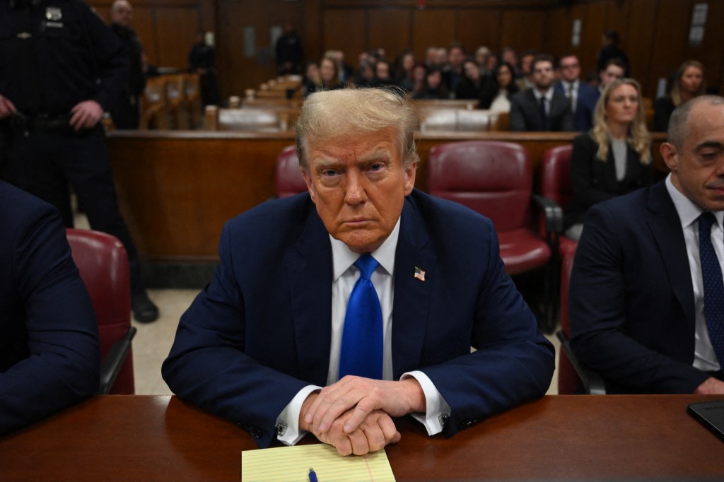 Former US president and Republican presidential candidate Donald Trump looks on at Manhattan Criminal Court during his trial for allegedly covering up hush money payments linked to extramarital affairs in New York on April 22, 2024. Donald Trump's unprecedented criminal trial is set for opening statements after final jury selection ended Friday, leaving the Republican presidential candidate facing weeks of hostile testimony that will overshadow his White House campaign. (Photo by ANGELA WEISS / POOL / AFP)