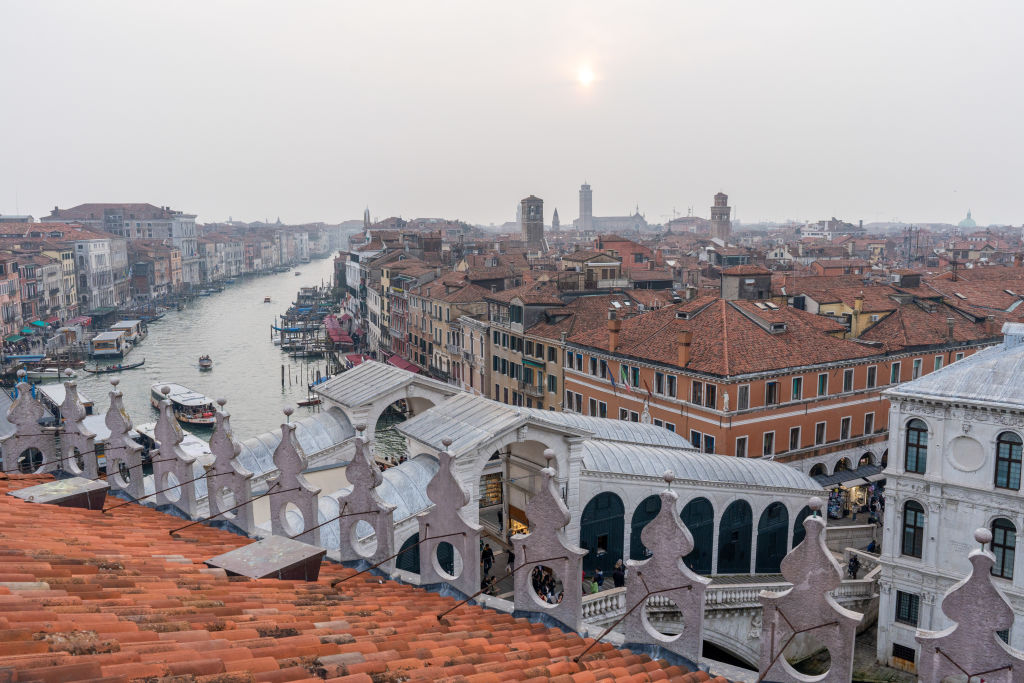 The Rialto Bridge over the Grand Canal from the rooftop of the Fondaco Dei Tadeschi in Venice, Italy, on Friday, March 15, 2024. Venice collected 37 million in overnight tourist taxes in 2023, with hotels charging guests anywhere between 1 and 5. Photographer: Nathan Laine/Bloomberg via Getty Images