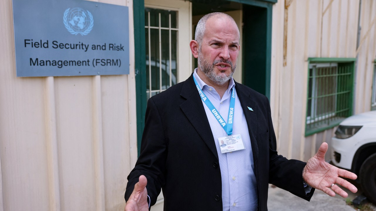 United Nations Relief and Works Agency for Palestine Refugees (UNRWA) Affairs Director in the West Bank Adam Bouloukos speaks at the agency's headquarters in east Jerusalem after "Israeli extremists" reportedly set ablaze the perimeter of the building on May 10, 2024. The attack came after two months of "Israeli extremists staging protests outside the UNRWA compound", agency chief Philippe Lazzarini said on X (formerly Twitter). (Photo by AHMAD GHARABLI / AFP)