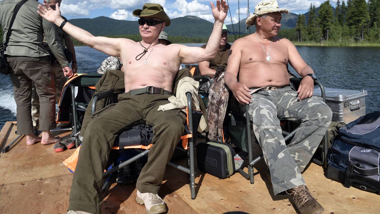 Russian President Vladimir Putin (L), accompanied by defence minister Sergei Shoigu