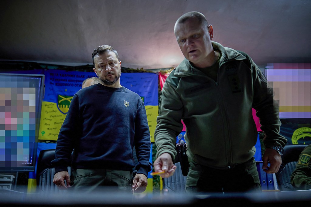 This handout photograph taken and released by the Ukrainian Presidential Press Service on May 16, 2024, shows Ukraine's President Volodymyr Zelensky (L) listening to Pavlo Fedosenko (R), commander of the 92nd separate assault brigade named after Ivan Sirko, during his visit to Kharkiv. Ukrainian president said on May 16, 2024 the military situation in the northeastern Kharkiv region was "extremely difficult," but still "under control," after a meeting with his military chiefs near the front line. (Photo by Handout / UKRAINIAN PRESIDENTIAL PRESS SERVICE / AFP) / RESTRICTED TO EDITORIAL USE - MANDATORY CREDIT "AFP PHOTO / HO/UKRAINIAN PRESIDENTIAL PRESS SERVICE" - NO MARKETING NO ADVERTISING CAMPAIGNS - DISTRIBUTED AS A SERVICE TO CLIENTS