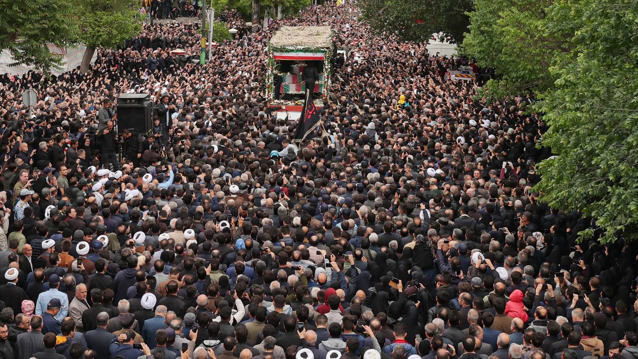 This handout picture provided by the Iranian president's office shows mourners walking in the funeral procession in Tabriz, the capital of Iran's East Azerbaijan province, on May 21, 2024 of late president Ebrahim Raisi and seven others killed with him in a helicopter crash two days ago. Tens of thousands of Iranians gathered in Tabriz on May 21 to mourn Raisi and seven members of his entourage who were killed in the crash on a fog-shrouded mountainside in northwestern Iran. (Photo by Iranian Presidency / AFP) / === RESTRICTED TO EDITORIAL USE - MANDATORY CREDIT "AFP PHOTO / HO / IRANIAN PRESIDENCY" - NO MARKETING NO ADVERTISING CAMPAIGNS - DISTRIBUTED AS A SERVICE TO CLIENTS ===