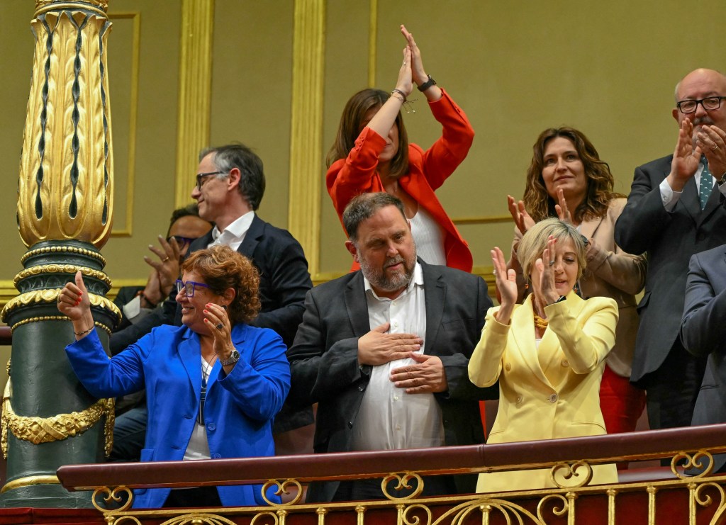 President of Catalan separatist party Esquerra Republicana de Catalunya - ERC (Republican Left of Catalonia) Oriol Junqueras (C) gestures as he celebrate after the final approval of the amnesty law for Catalan separatists during a plenary session at the Congress in Madrid, on May 30, 2024. Spain lawmakers approved a controversial law to grant amnesty to Catalan separatists involved in the failed 2017 independence bid, at the Congress in Madrid, on May 30, 2024. (Photo by JAVIER SORIANO / AFP)