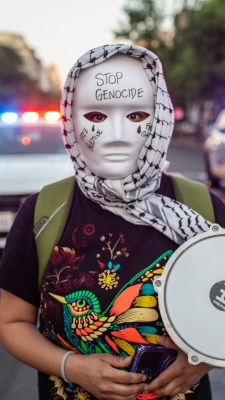 A demonstrator wearing traditional Palestinian Keffiyeh