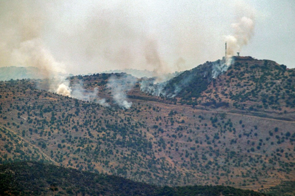 This picture taken from Marjeyoun in southern Lebanon shows smoke billowing across the border following a barrage of rockets on an Israeli outpost near the hills of Kfar Shouba on June 12, 2024 amid ongoing cross-border tensions as fighting continues between Israel and Hamas militants in the Gaza Strip. (Photo by RABIH DAHER / AFP)