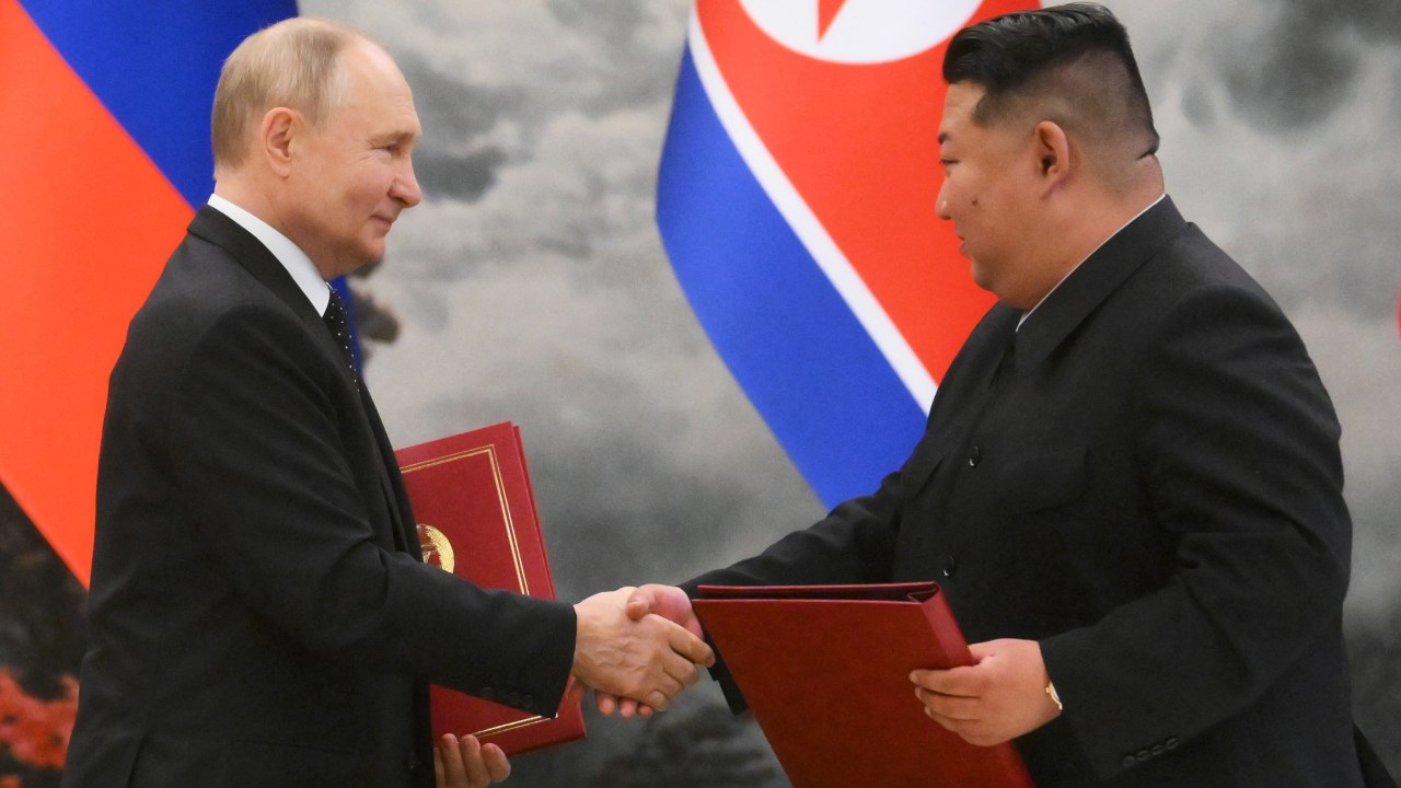 In this pool photograph distributed by the Russian state agency Sputnik, Russian President Vladimir Putin (L) shakes hands with North Korea's leader Kim Jong Un (R) after a signing ceremony following their bilateral talks at Kumsusan state residence in Pyongyang, on June 19, 2024. (Photo by Kristina Kormilitsyna / POOL / AFP) / -- Editor's note : this image is distributed by the Russian state owned agency Sputnik -