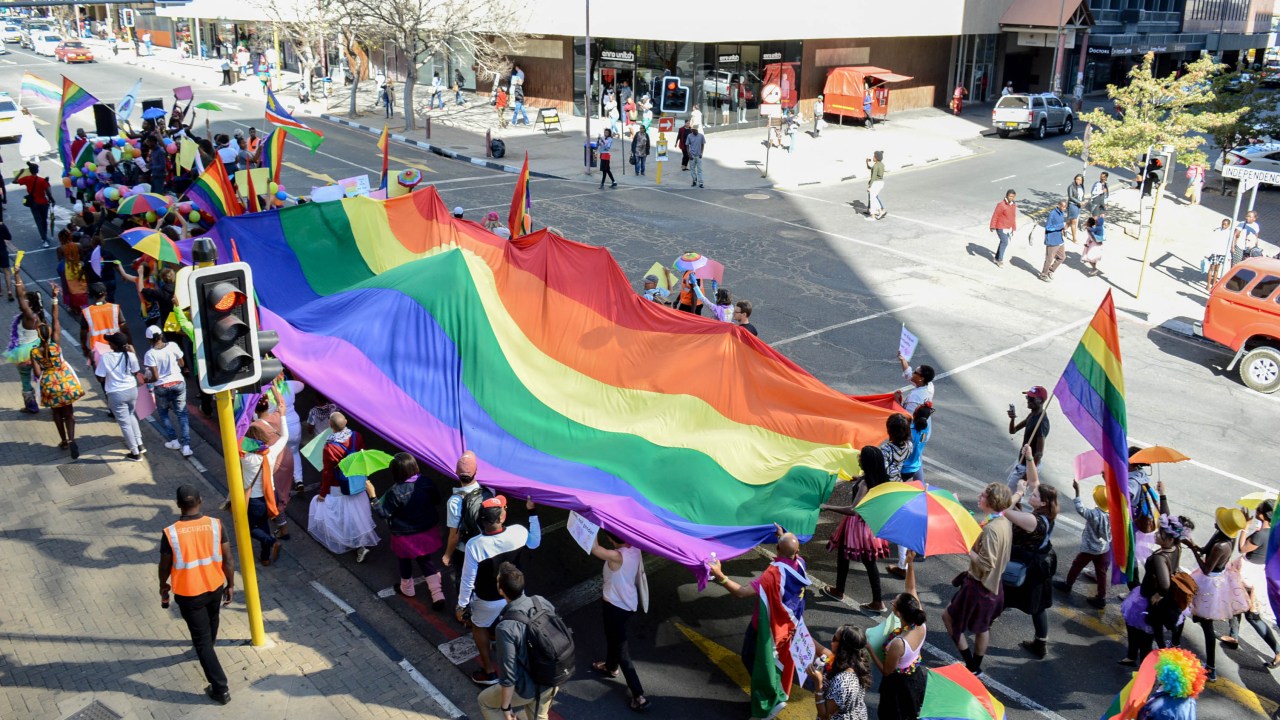 (FILES) Dozens of people cheer and dance as they take part in the Namibian Lesbians, Gay, Bisexual and Transexual (LGBT) community pride Parade in the streets of the Namibian Capitol on July 29, 2017 in Windhoek. A top Namibian court on June 21, 2024 struck down the African country's colonial-era laws criminalising same-sex relationships, in a victory for the LGBTQ community. "The common law offence of sodomy is declared unconstitutional and invalid," the high court in the capital, Windhoek, wrote in its verdict. It also declared unconstitutional the offence of "unnatural sexual offences". (Photo by Hildegard Titus / AFP)