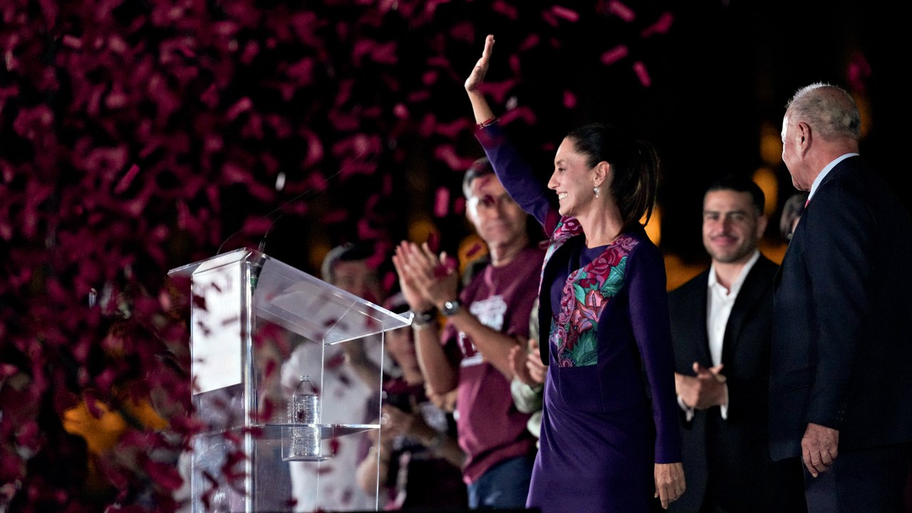 Future President Claudia Sheinbaum waves to supporters at the Zocalo, Mexico City's main square, after the National Electoral Institute announced she held an irreversible lead in the election, early Monday, June 3, 2024. (AP Photo/Marco Ugarte)
