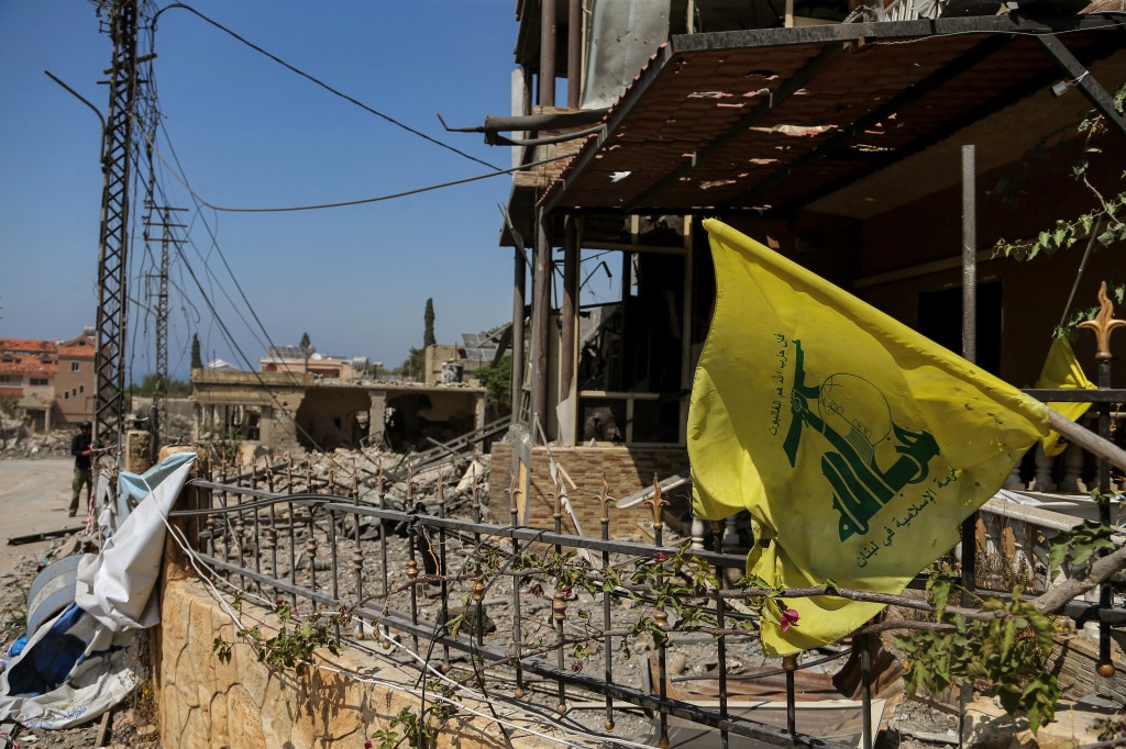 04 June 2024, Lebanon, Naqura: A Hezbollah flag is seen hanged on rubble of destroyed houses caused by Israeli air raids in the Lebanese southern village of Naqura, located at the Lebanese-Israeli border. An Israeli drone raided on a motorcycle killing a Hezbollah militants and heavily wounding another. Photo: Marwan Naamani/dpa (Photo by Marwan Naamani/picture alliance via Getty Images)