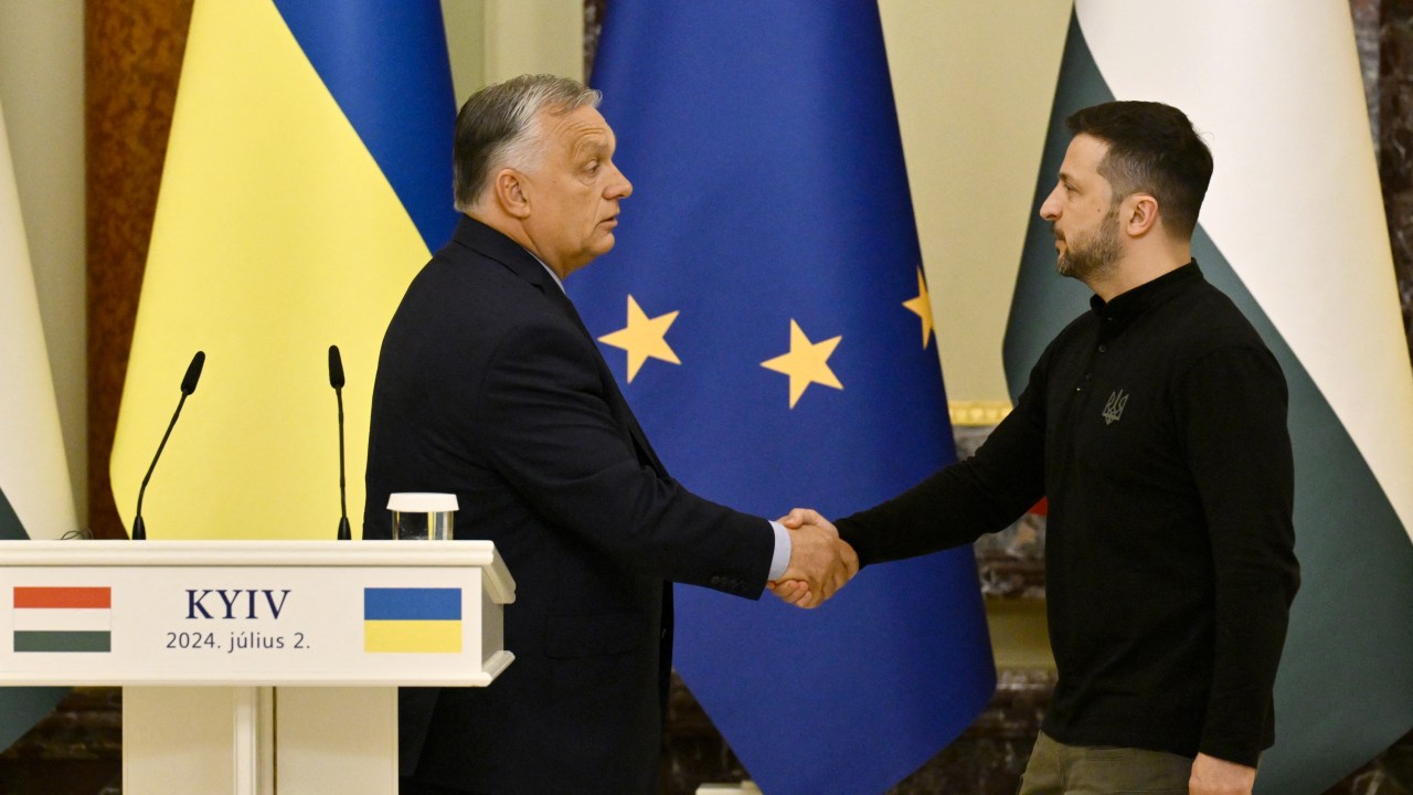 Ukraine's President Volodymyr Zelensky (R) shakes hands with Hungary's Prime Minister Viktor Orban after delivering a press conference in Kyiv on July 2, 2024, amid the Russian invasion of Ukraine. (Photo by Genya SAVILOV / AFP)