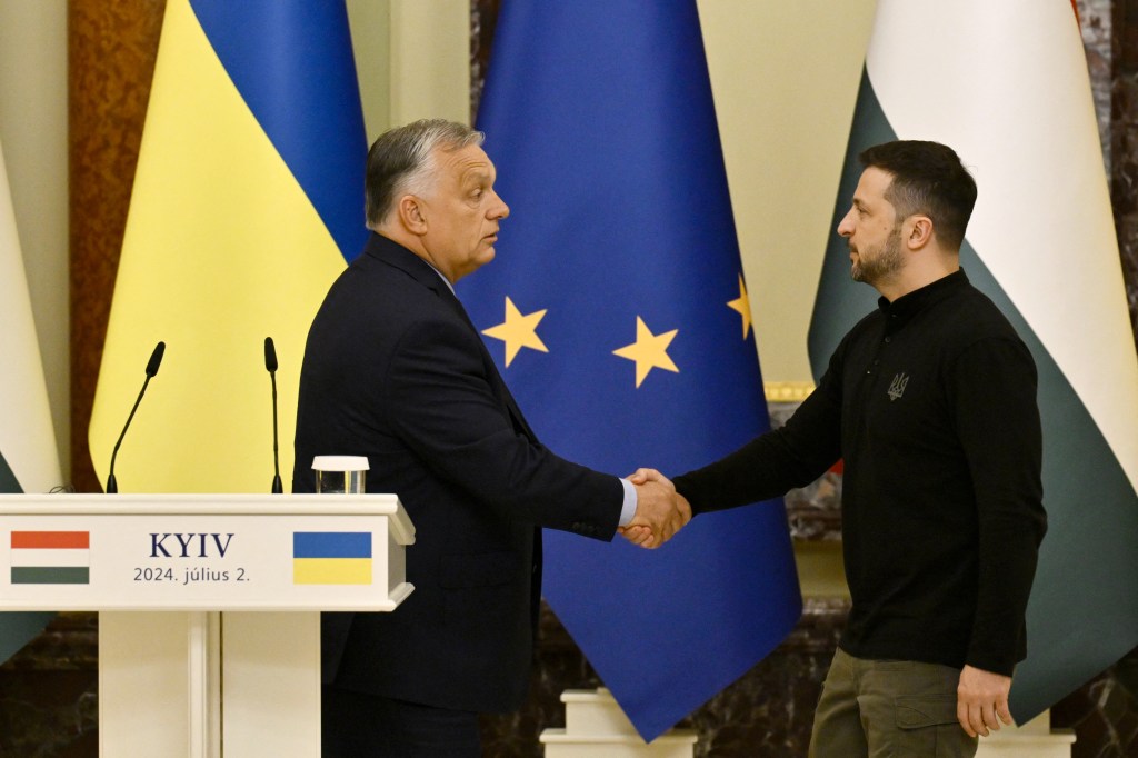 Ukraine's President Volodymyr Zelensky (R) shakes hands with Hungary's Prime Minister Viktor Orban after delivering a press conference in Kyiv on July 2, 2024, amid the Russian invasion of Ukraine. (Photo by Genya SAVILOV / AFP)