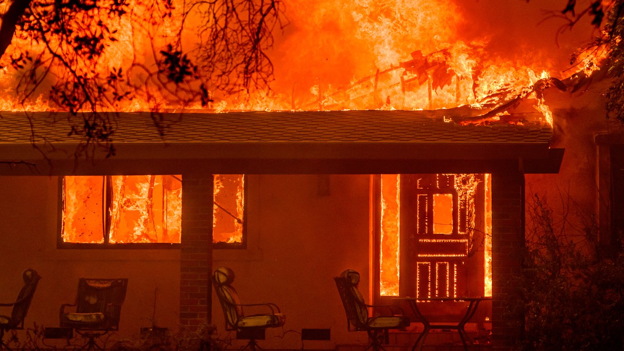 Flames engulf a home during the Thompson fire in Oroville, California on July 2, 2024. A heatwave is sending temperatures soaring resulting in red flag fire warnings throughout the state. (Photo by JOSH EDELSON / AFP)