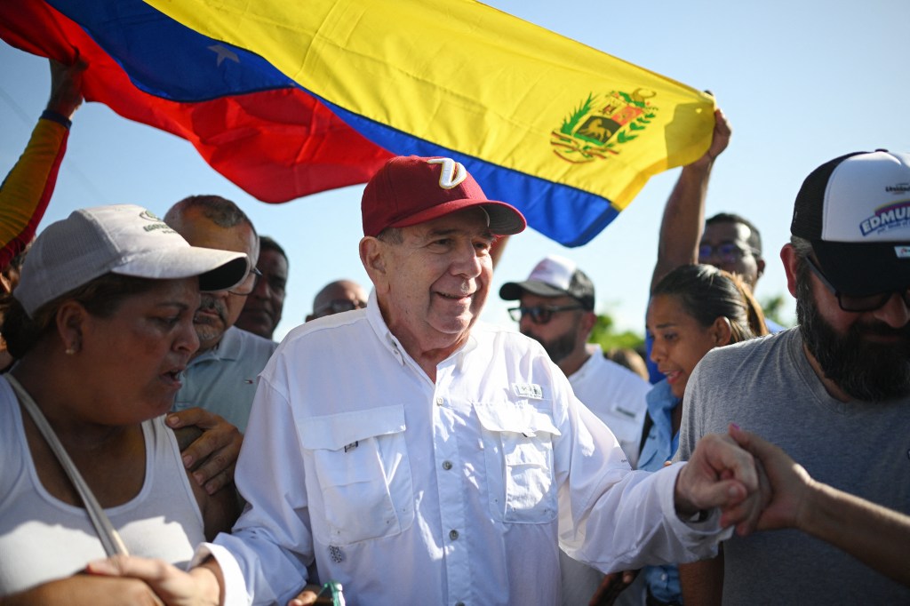 (FILES) The Venezuelan opposition presidential candidate for the Plataforma Unitaria Democratica party, Edmundo Gonzalez Urrutia, greets supporters upon his arrival at the campaign act in Barlovento, Miranda State, Venezuela, on June 26, 2024. Edmundo Gonzalez Urrutia, a soft-spoken grandfather who eschews the spotlight, is the Venezuelan opposition's hope for unseating strongman Nicolas Maduro in July 28 presidential elections. (Photo by Federico PARRA / AFP)