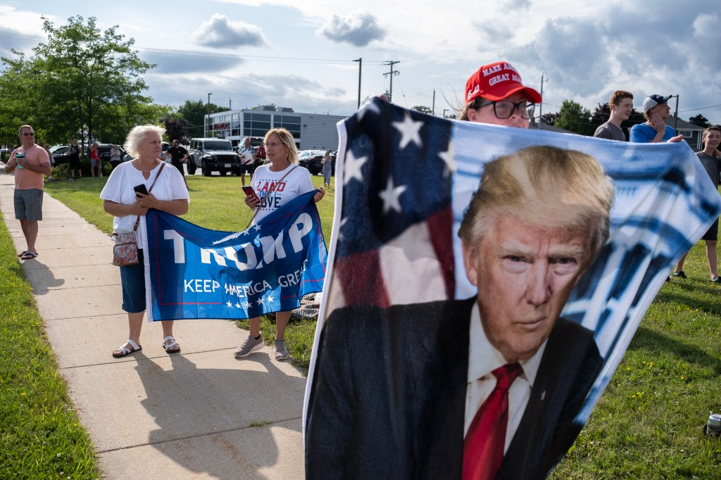 MILWAUKEE, WISCONSIN - JULY 14: Supporters of Republican presidential candidate, former U.S. President Donald await his arrival at Milwaukee Mitchell International Airport on July 14, 2024 in Milwaukee, Wisconsin. Law enforcement officials began final preparations on the eve of the Republican National Convention where Trump is expected to formally receive the GOP nomination for the 2024 U.S. Presidential election. Trump suffered minor injuries during a campaign rally on on July 13 in Butler, Pennsylvania after a gunman opened fired, killing one person and injuring two critically. Jim Vondruska/Getty Images/AFP (Photo by Jim Vondruska / GETTY IMAGES NORTH AMERICA / Getty Images via AFP)