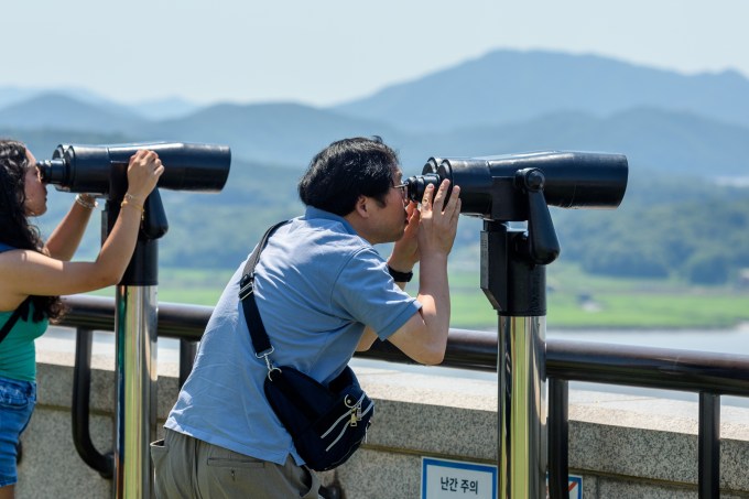 Visitors use binoculars to view the North Korean side from