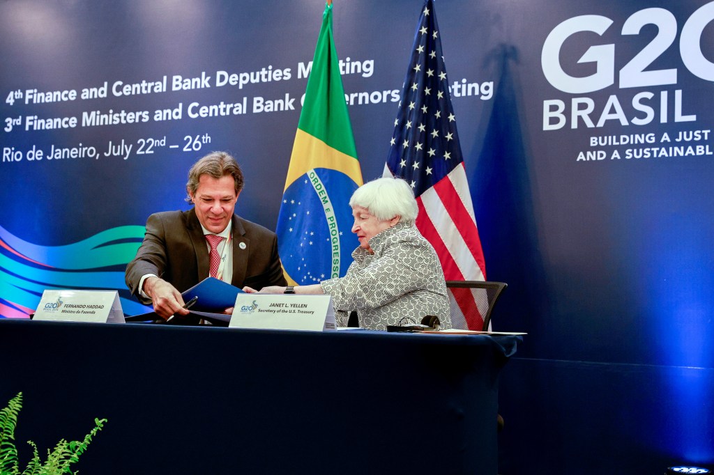 Janet Yellen, US Treasury secretary, right, and Fernando Haddad, Brazil's finance minister, sign a climate agreement during the Group of 20 (G-20) finance ministers and central bank governors meeting in Rio de Janeiro, Brazil, on Friday, July 26, 2024. Group of 20 finance chiefs are set to leave Brazil's controversial plan for a global billionaires tax to future summits, pledging in a draft communique to continue discussions after debating the idea this week in Rio de Janeiro. Photographer: Dado Galdieri/Bloomberg via Getty Images
