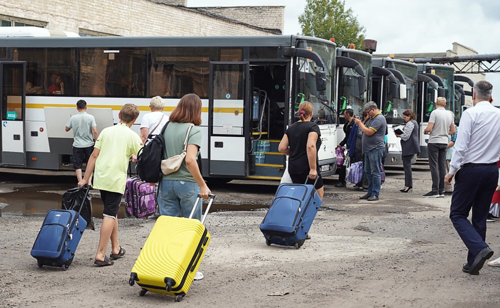 This handout photograph taken and released by the Government of Kursk region of Russia on August 9, 2024, shows women and children being evacuated from the town of Rylsk in Kursk region. Russia said that it was deploying more troops and munitions to a border region where Ukraine had mounted a major ground offensive, as Ukraine said a Russian strike on a supermarket in its east killed 11 people. Kyiv's troops have been driving into Russia's western Kursk region since Tuesday in a surprise offensive that appears to be the most significant attack on Russian soil since Moscow invaded in February 2022. (Photo by HANDOUT / GOVERNMENT OF KURSK REGION / AFP) / RESTRICTED TO EDITORIAL USE - MANDATORY CREDIT "AFP PHOTO / GOVERNMENT OF KURSK REGION" - NO MARKETING NO ADVERTISING CAMPAIGNS - DISTRIBUTED AS A SERVICE TO CLIENTS