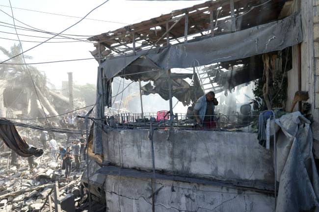 A man inspects the debris a day after an Israeli airstrike in Beirut's southern suburb of Jnah on October 22, 2024, amid the ongoing war between Israel and Hezbollah. (Photo by IBRAHIM AMRO / AFP)