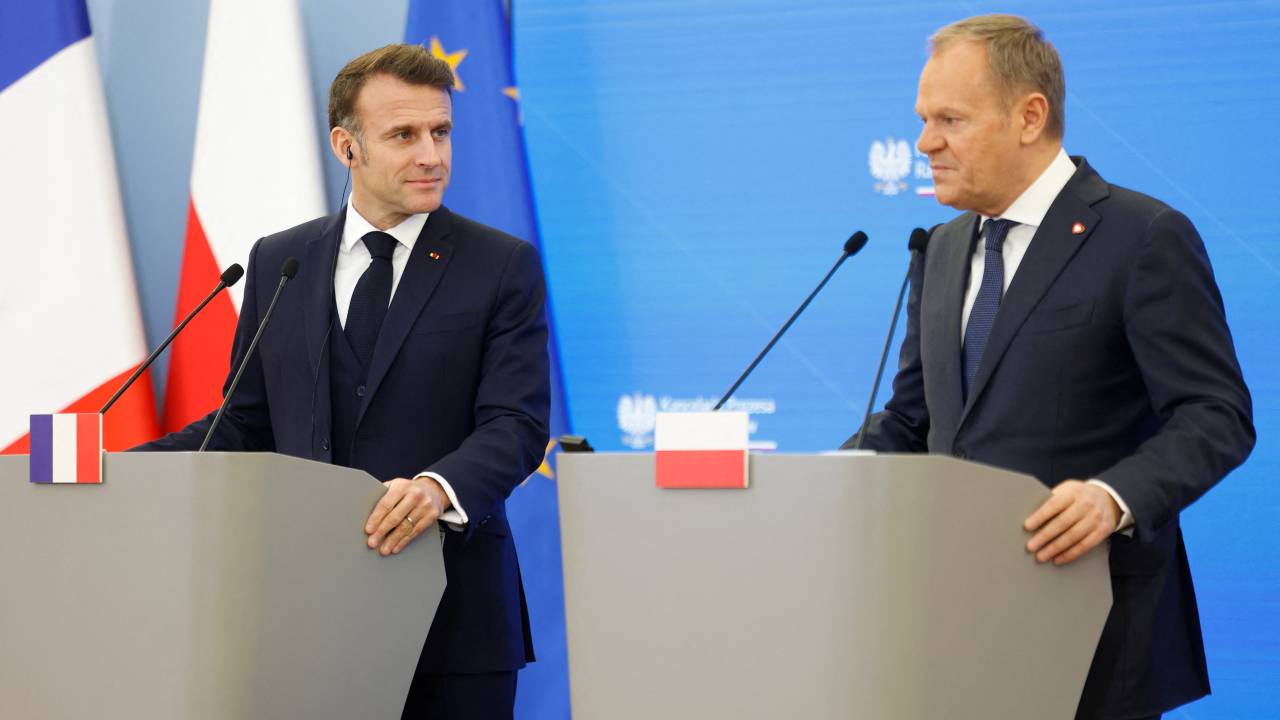 Poland's Prime Minister Donald Tusk (R) and French President Emmanuel Macron give a joint press conference in Warsaw, Poland, on December 12, 2024. French President Emmanuel Macron visits Poland on a one day trip to report on recent talks with his Ukraine and US counterparts. (Photo by Wojtek RADWANSKI / AFP)