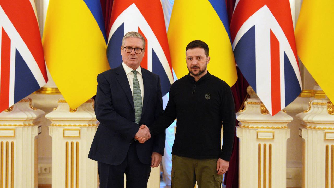 Britain's Prime Minister Keir Starmer (L) shakes hands with Ukrainian President Volodymyr Zelensky ahead of a meeting at Mariinsky Palace in Kyiv on January 16, 2025. Starmer arrived in Kyiv on an unannounced visit to shore up support for Ukraine after nearly three years of war, officials said. (Photo by Carl Court / POOL / AFP)