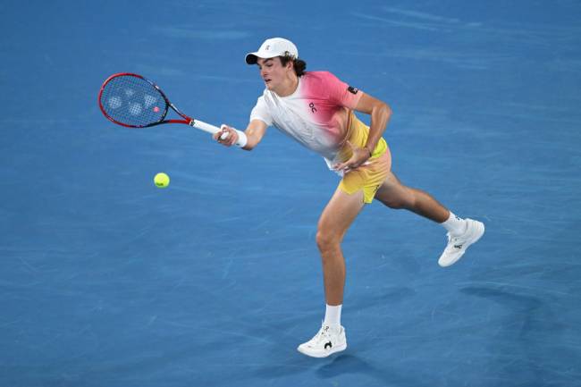 MELBOURNE, AUSTRALIA - JANUARY 14: Joao Fonseca of Brazil plays a forehand against Andrey Rublev in the Men's Singles First Round match during day three of the 2025 Australian Open at Melbourne Park on January 14, 2025 in Melbourne, Australia. (Photo by Hannah Peters/Getty Images)