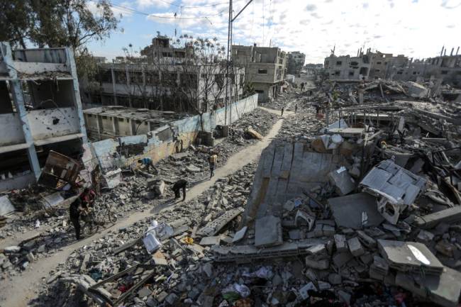 Palestinians continue to return to their homes as ceasefire comes into force in Gaza DEIR AL BALAH, GAZA - JANUARY 20: A general view of the heavily damaged and partially collapsed buildings as displaced Palestinians continue to return their houses after the ceasefire and hostage-prisoner swap deal between Hamas and Israel at Bureij refugee camp in Deir al-Balah, Gaza on January 20, 2025. (Photo by Ali Jadallah/Anadolu via Getty Images)